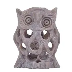 Mystical White Owl Statue by Design Toscano. It is a decorative sculpture of a snowy owl.